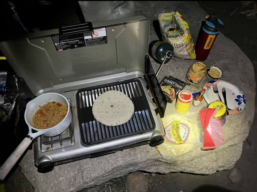 Solo camping preparing food