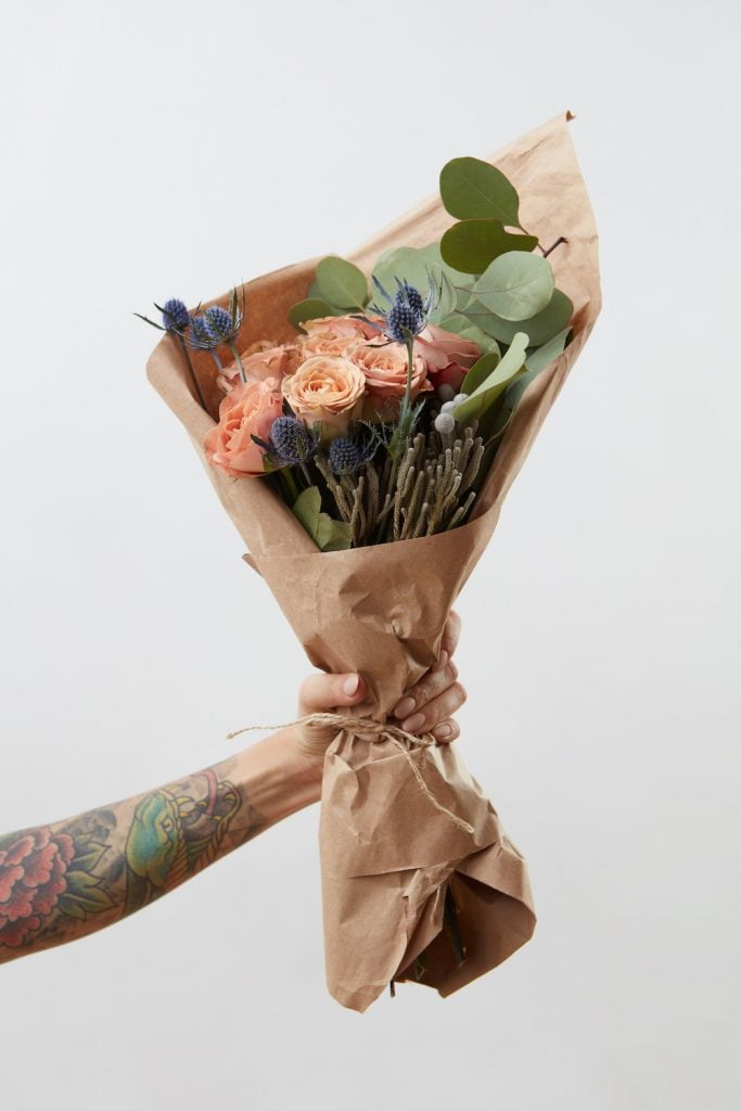 Eco friendly gift ideas for mother's day | tattooed hand holding flowers for mother's day