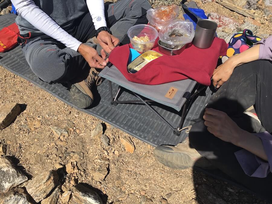 Some hikers pack blankets and tables to eat at the summit.