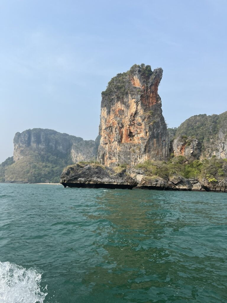The breathtaking view of a rock formation in the water, perfect for budget travelers exploring thailand.